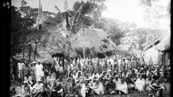 Rassemblement d’une population d’origine servile, des travailleurs « engagés », le 1er janvier à Nyumɓadjuu, une plantation appartenant au colon Léon Humblot. Photographie prise entre 1890 et 1896. © ANOM